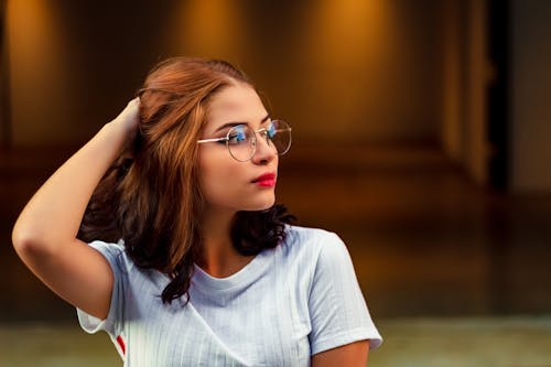 Free Photo of Woman Wearing Eyeglasses While Holing Her Hair Stock Photo