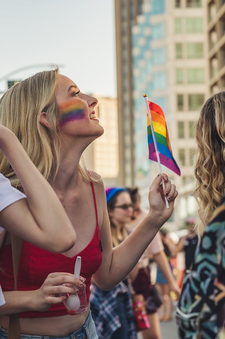 Photo Of Woman Holding Rainbow Flag