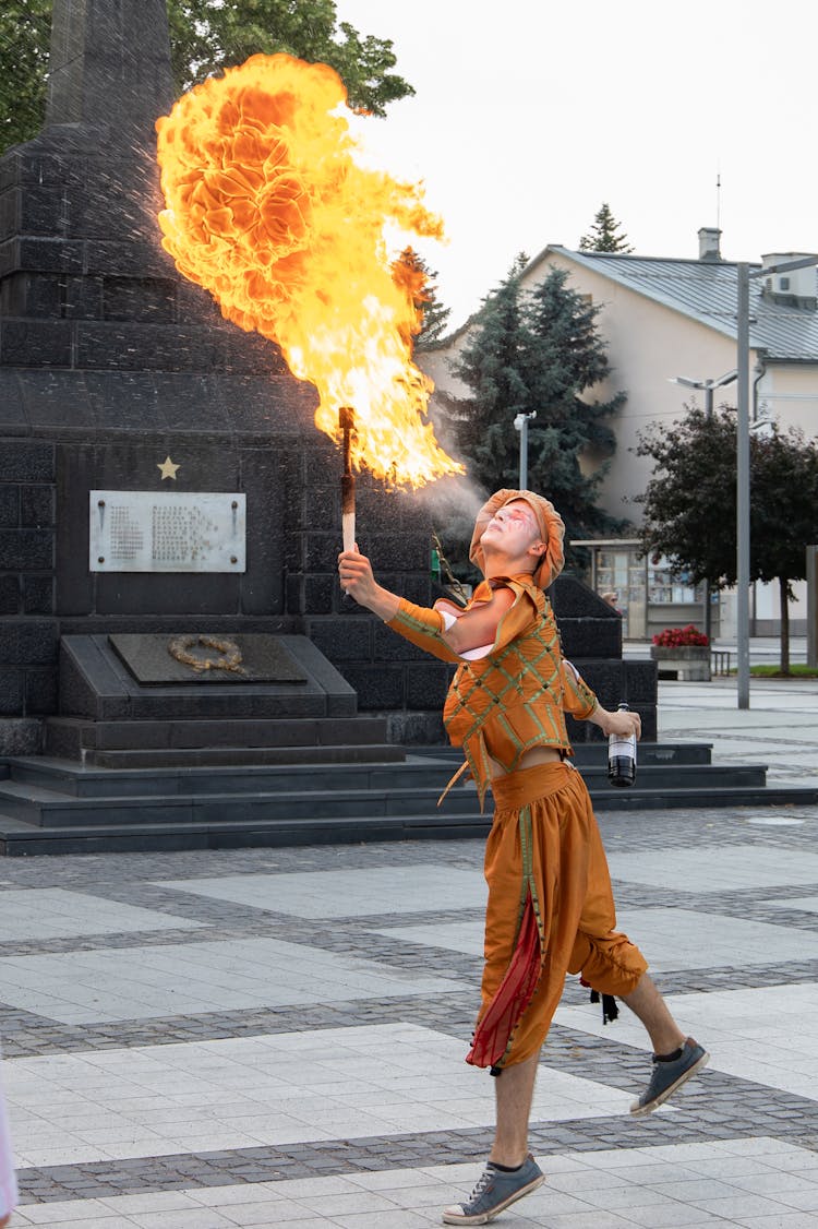 Photo Of Person Fire Breathing On Pavement