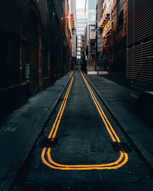 Free Photo of Empty Alley in Between Buildings Stock Photo