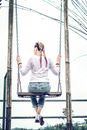 Back View Photo of Woman Swinging