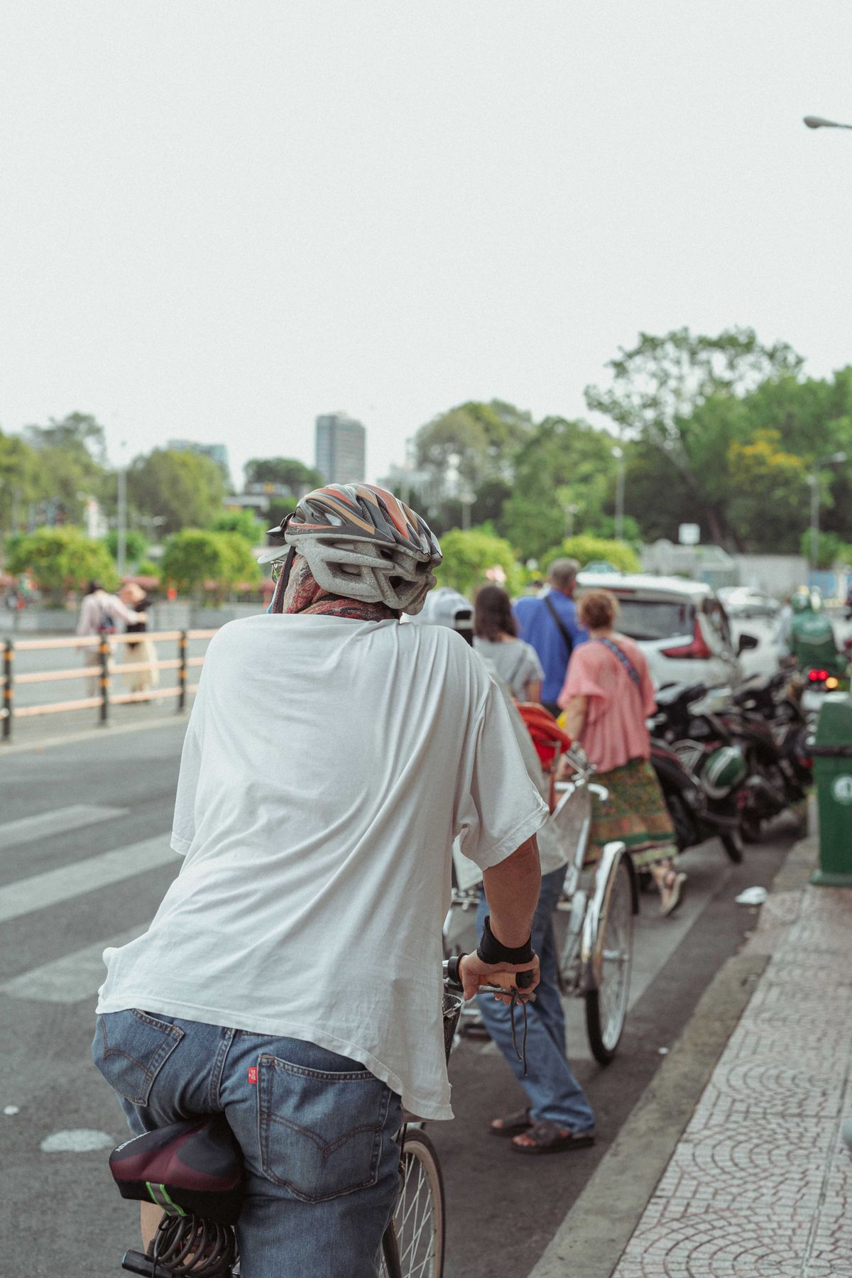 Helmeted cyclist navigating a busy urban street