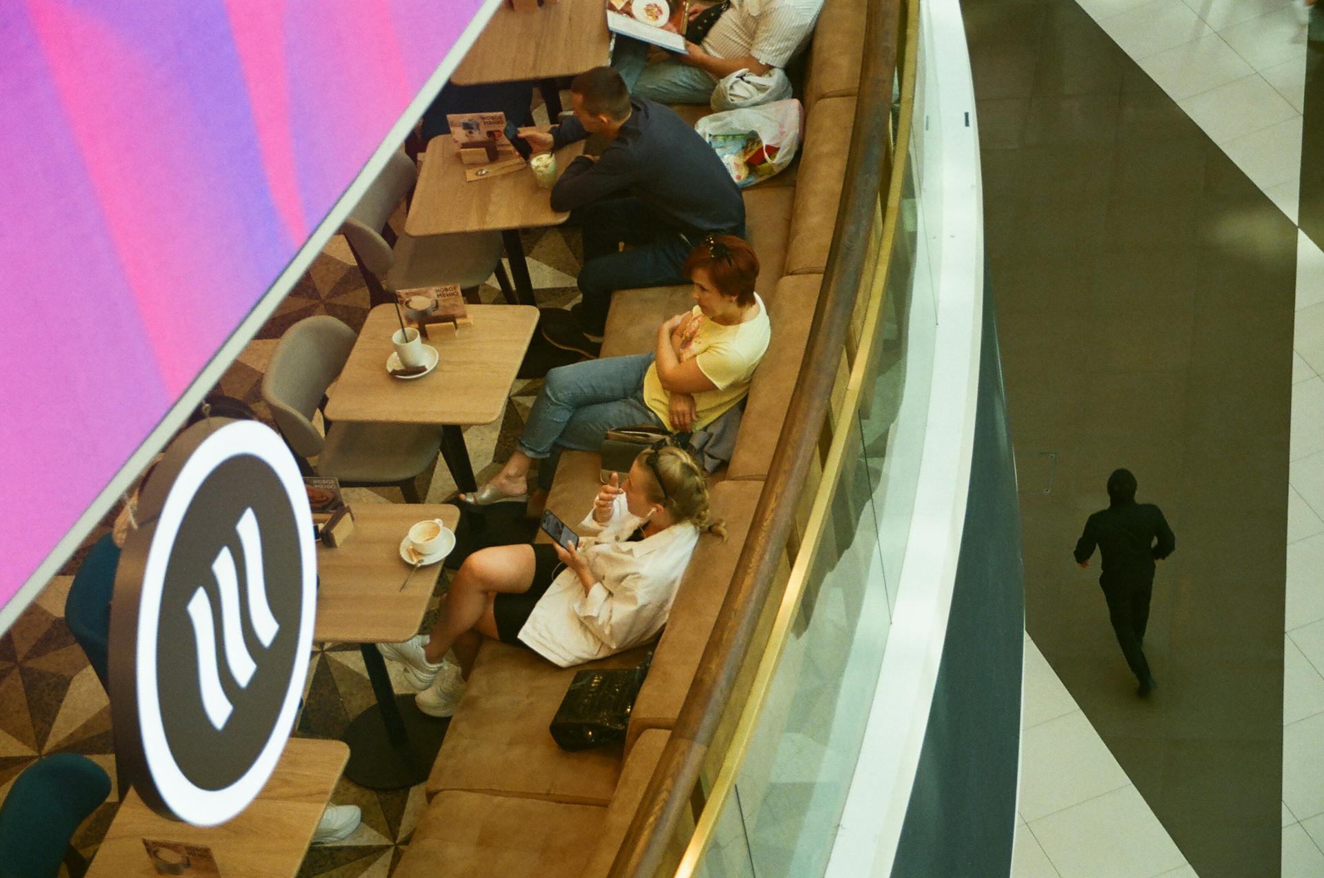 Aerial view of a café inside a shopping mall with people sitting and relaxing.