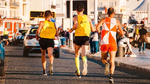 Three People Running in a Road