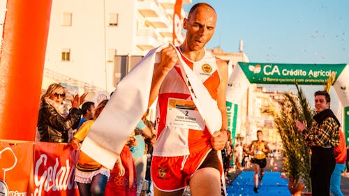 Man Holding White Finish Line Band Near People