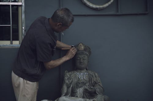 Man Sculpting A Statue