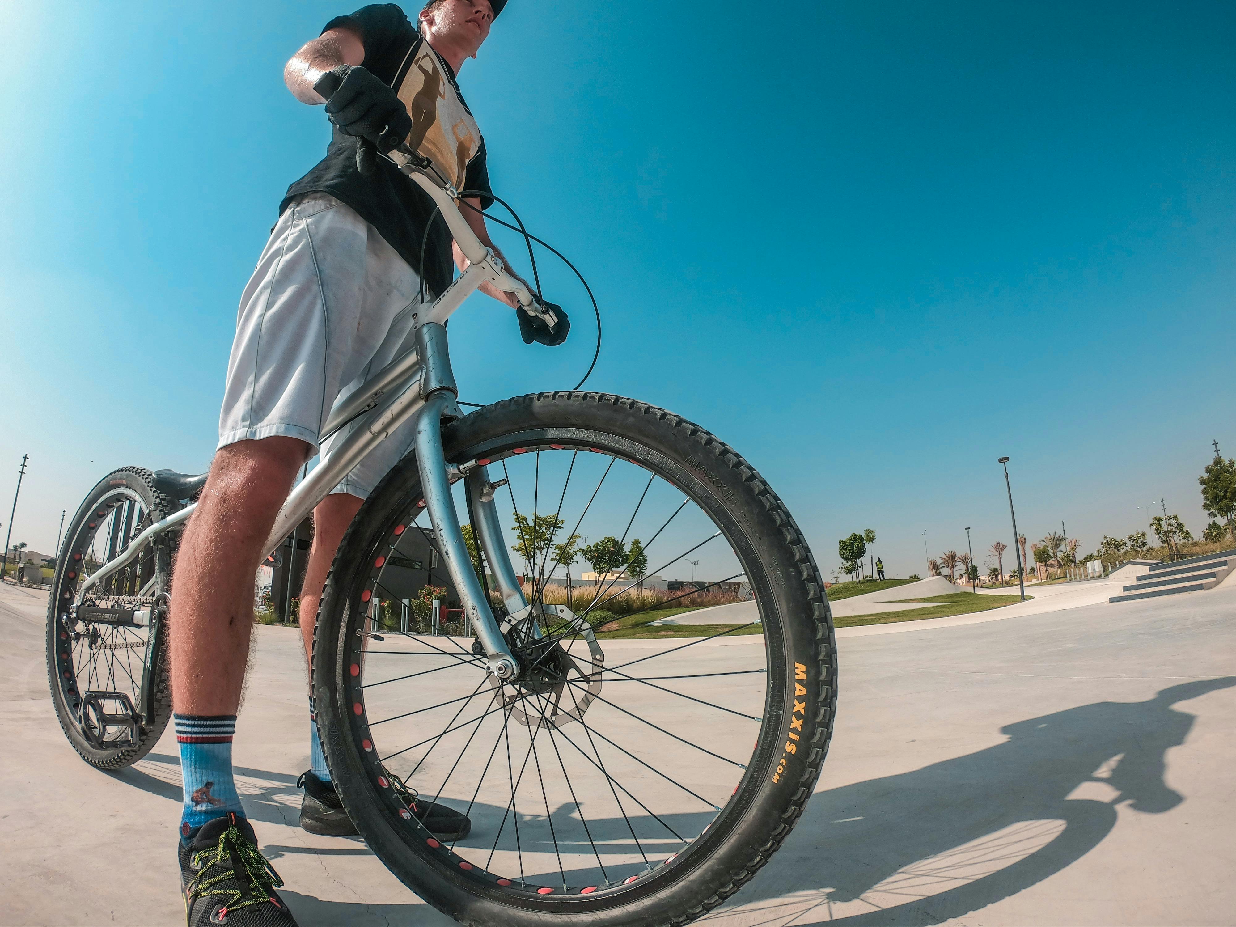 Low Angle Photography of a Man Holding Bike