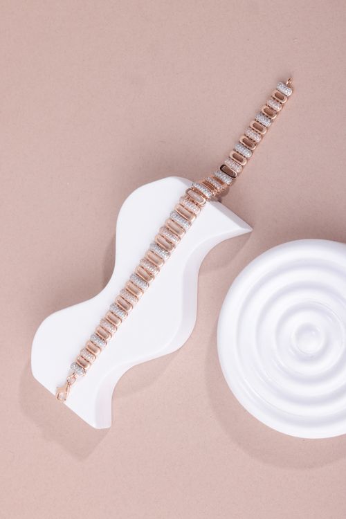 Free Stylish gold bracelet showcased on geometric white props with a beige background for minimalist elegance. Stock Photo