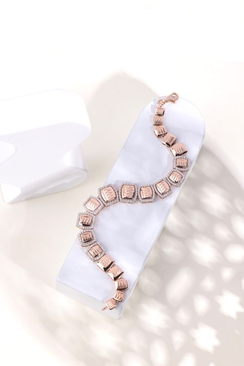 Free A close-up of a stylish rose gold necklace elegantly displayed on a white surface. Stock Photo