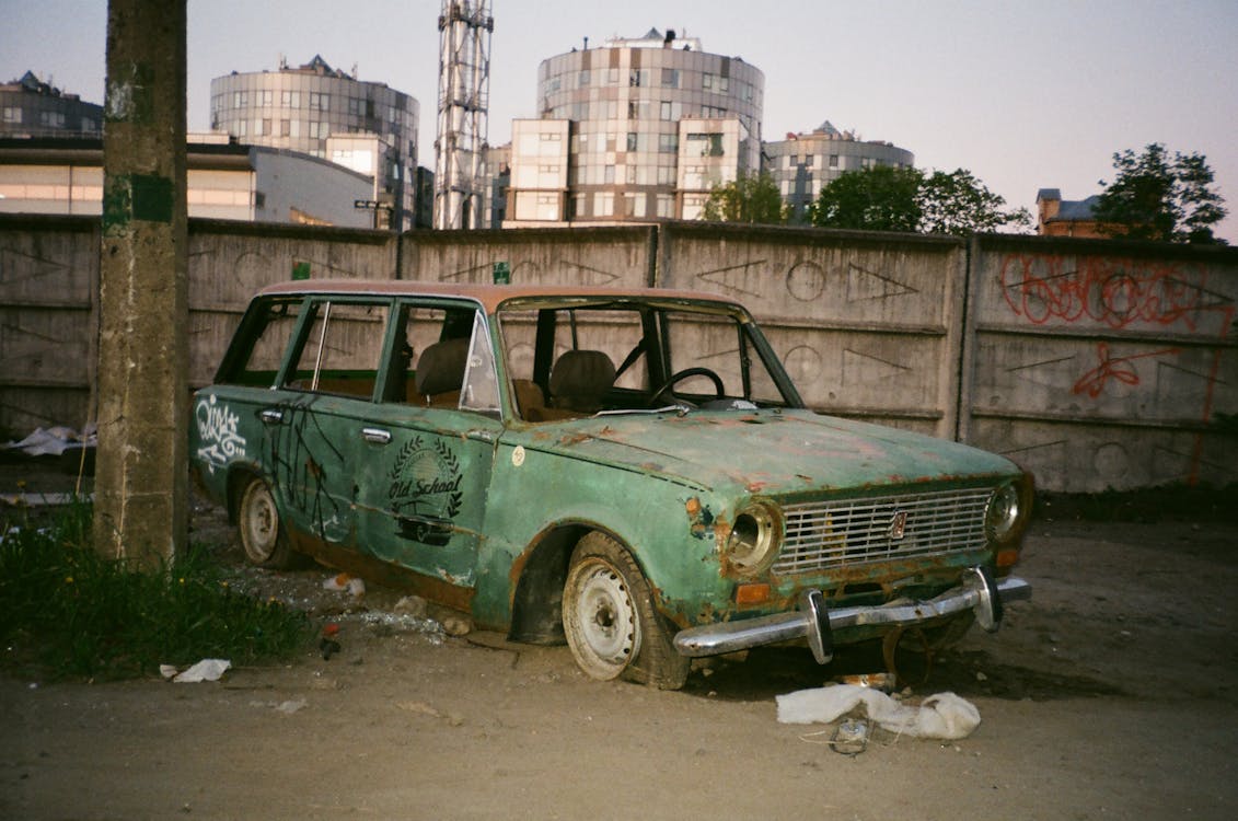 Free Photo of Abandoned Green Car Beside Post Stock Photo