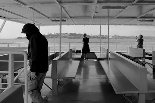 A black and white photo of people on a boat