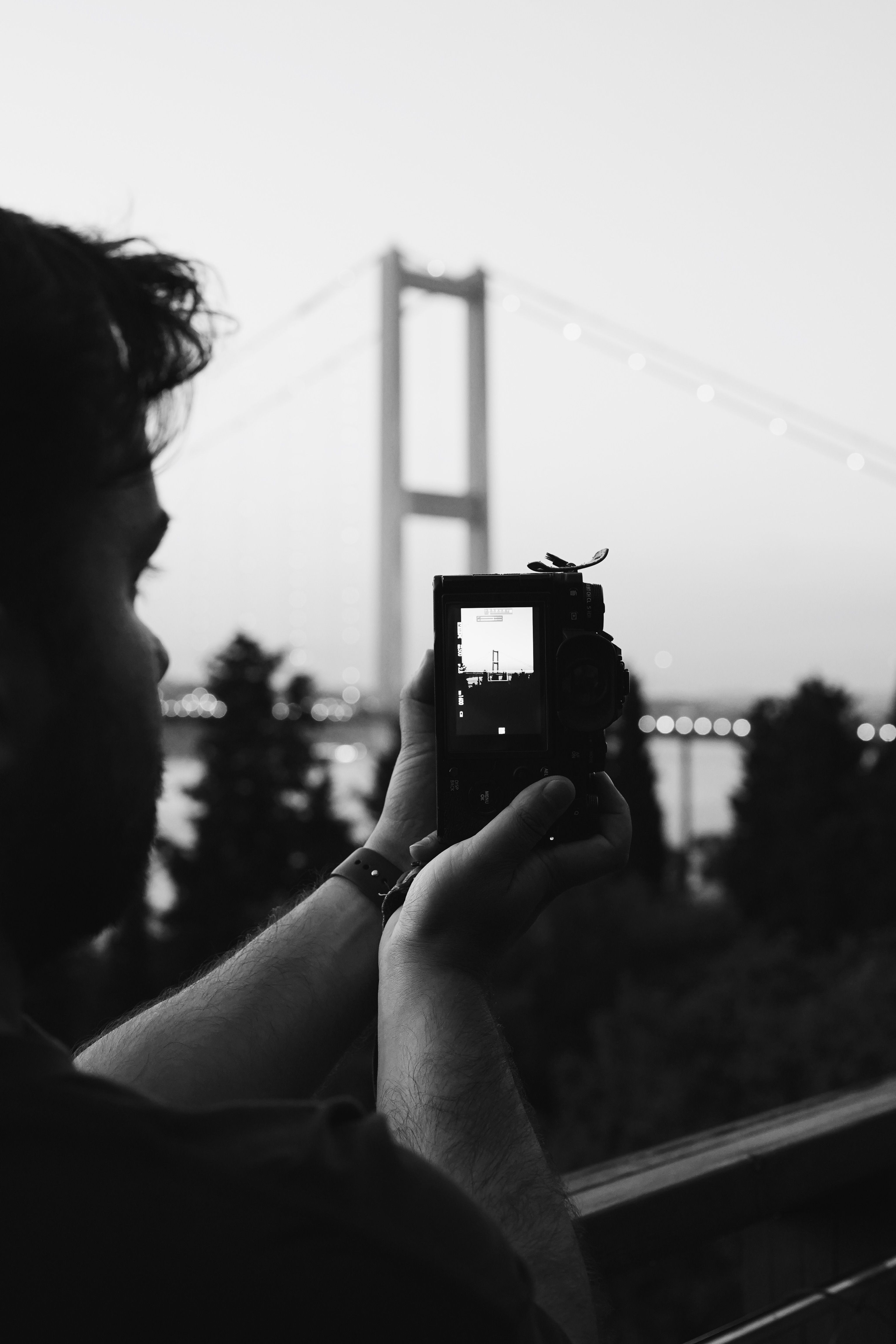Man Photographing Bridge with Camera · Free Stock Photo