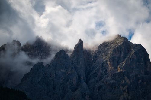 Free Stunning rocky peaks of the Sexten Dolomites shrouded in clouds, creating a dramatic landscape. Stock Photo