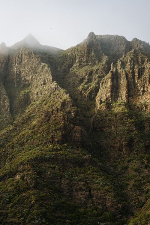 Free Stunning view of rugged mountain peaks bathed in soft morning light, showcasing nature's grandeur. Stock Photo