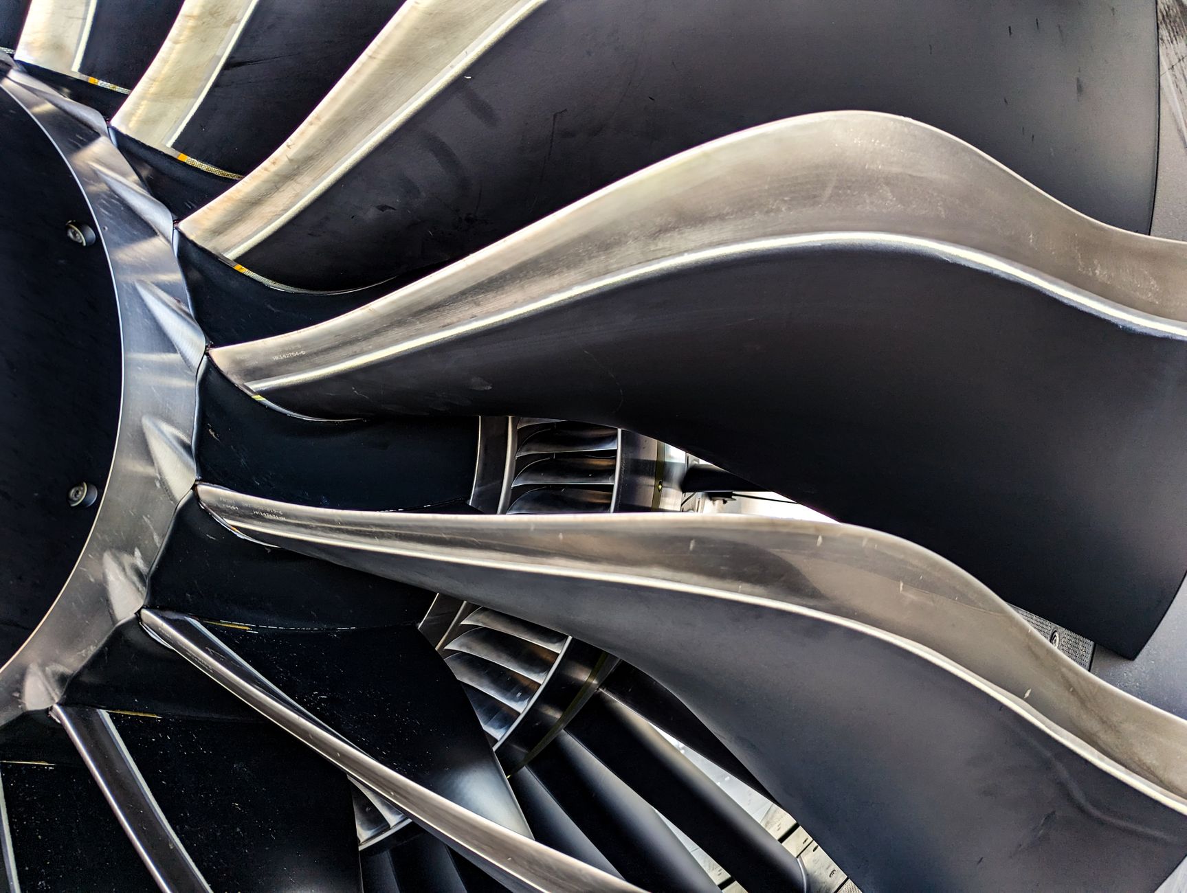 Detailed close-up of metal turbine blades showcasing engineering and aerodynamic design.