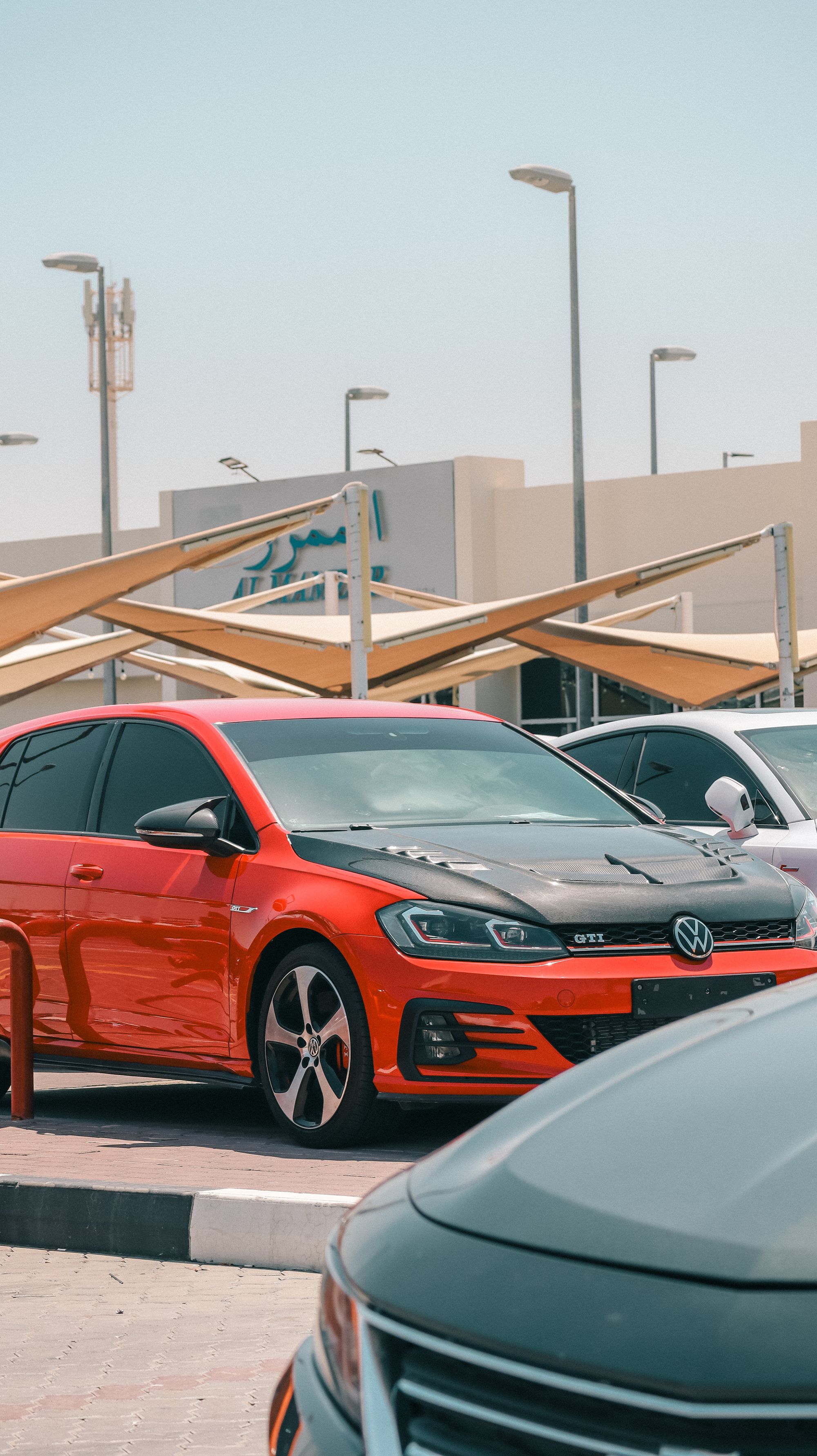 Shows a current-generation Volkswagen Golf GTI on a dealer lot, directly matching the article