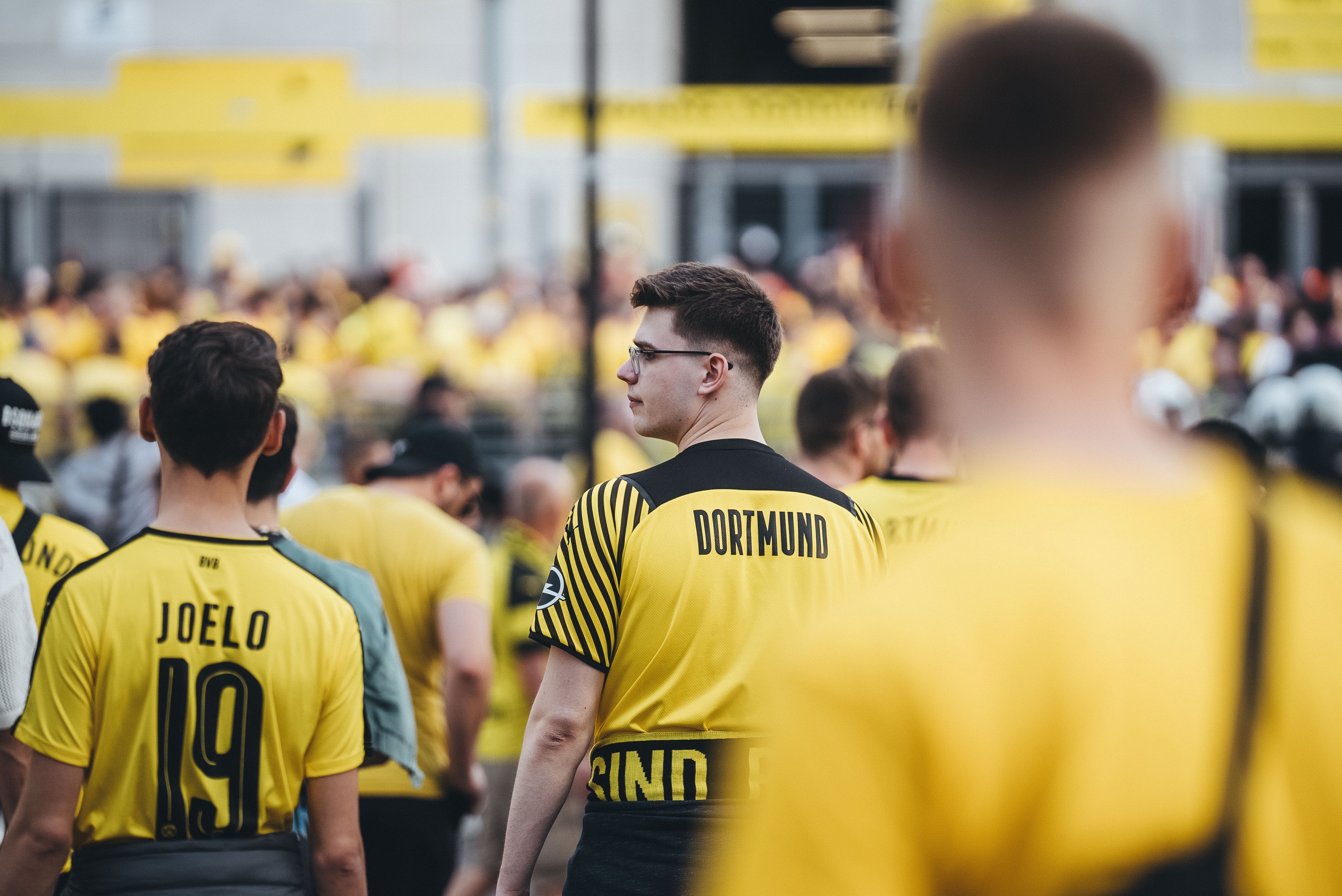 A group of people wearing yellow shirts and black shorts · Free Stock Photo