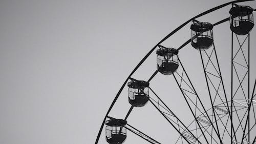 A ferris wheel is shown in black and white