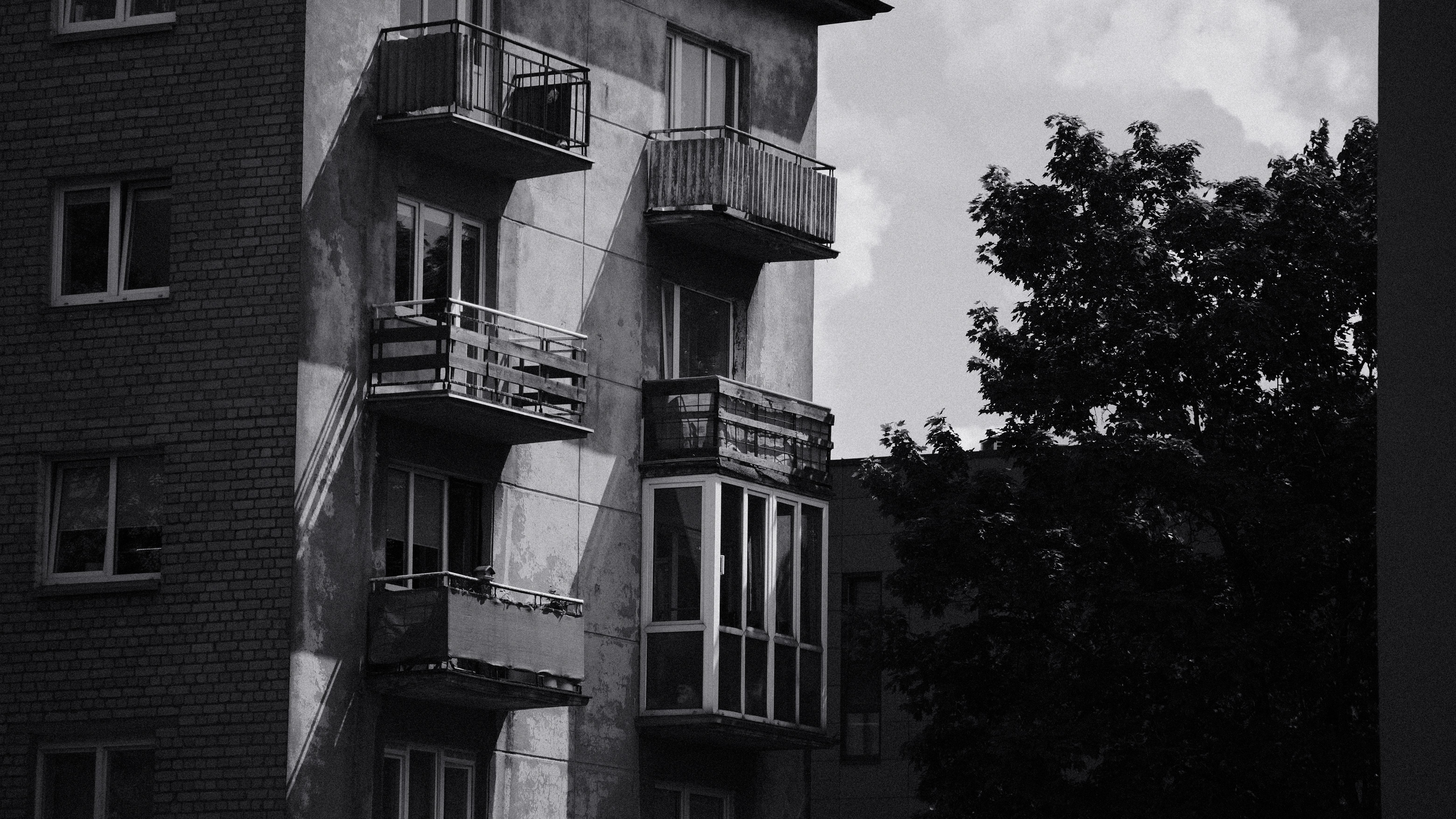Black and white photo of a building with balconies · Free Stock Photo