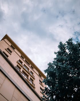 低角度拍摄的布鲁塞尔城市建筑引人注目，在阴云密布的天空下捕捉现代建筑的韵味