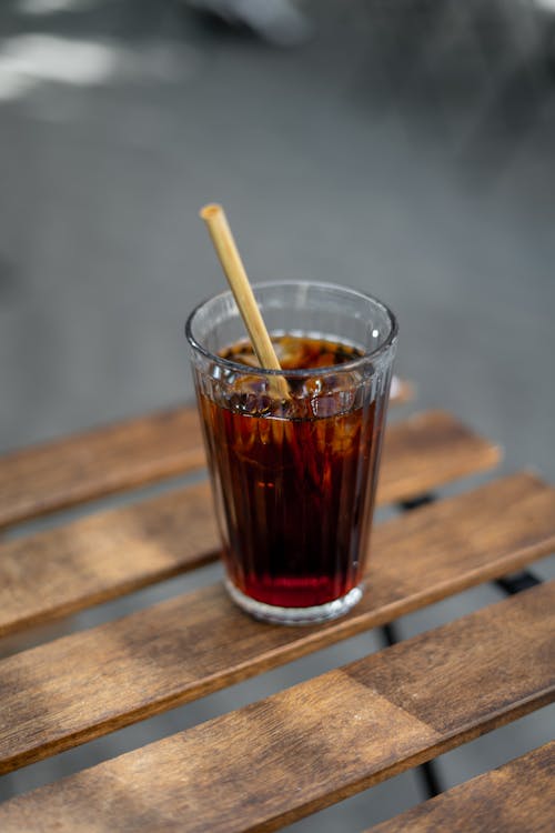 A glass of iced coffee with a straw