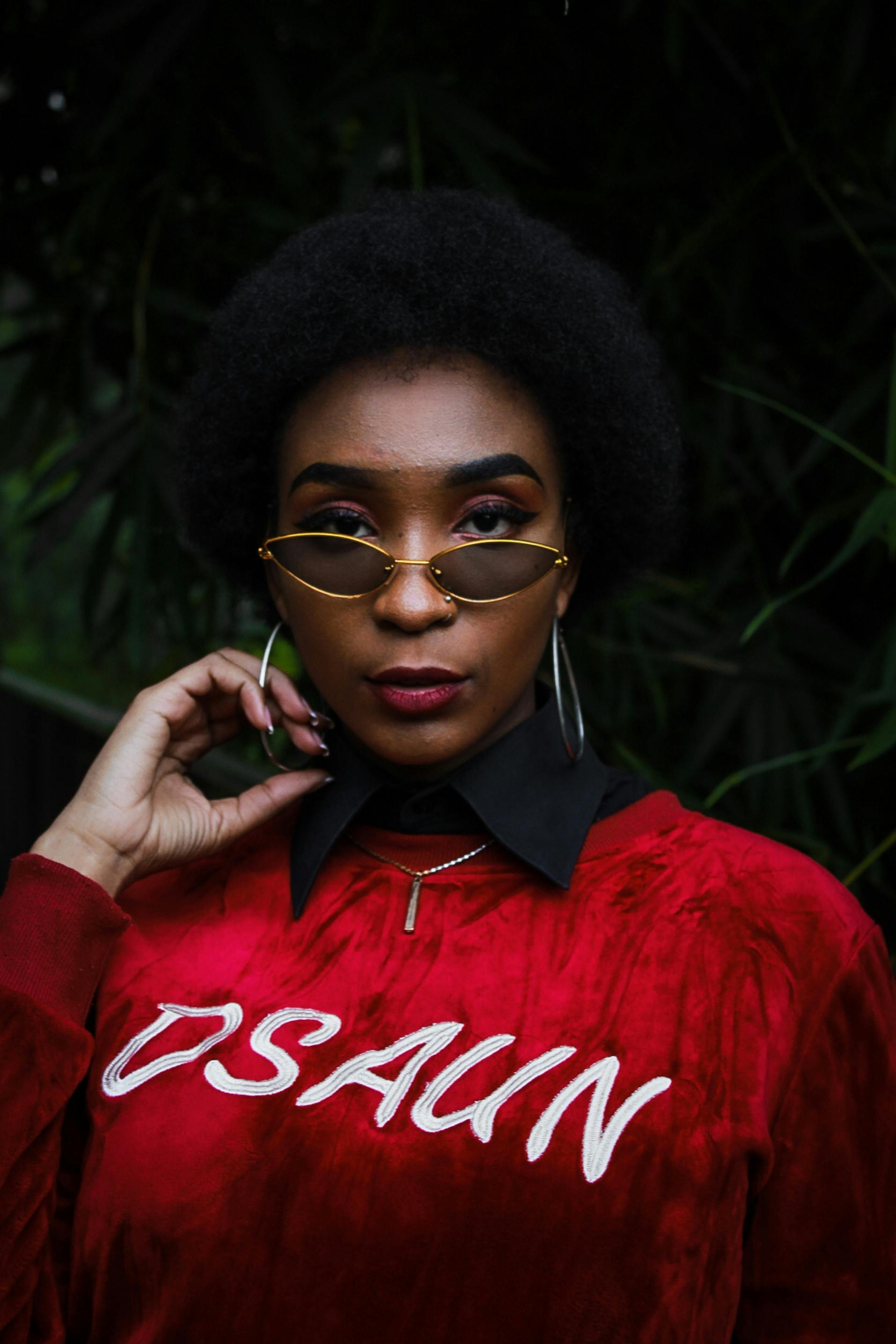 Photo of Woman Wearing Red Sweater and Sunglasses