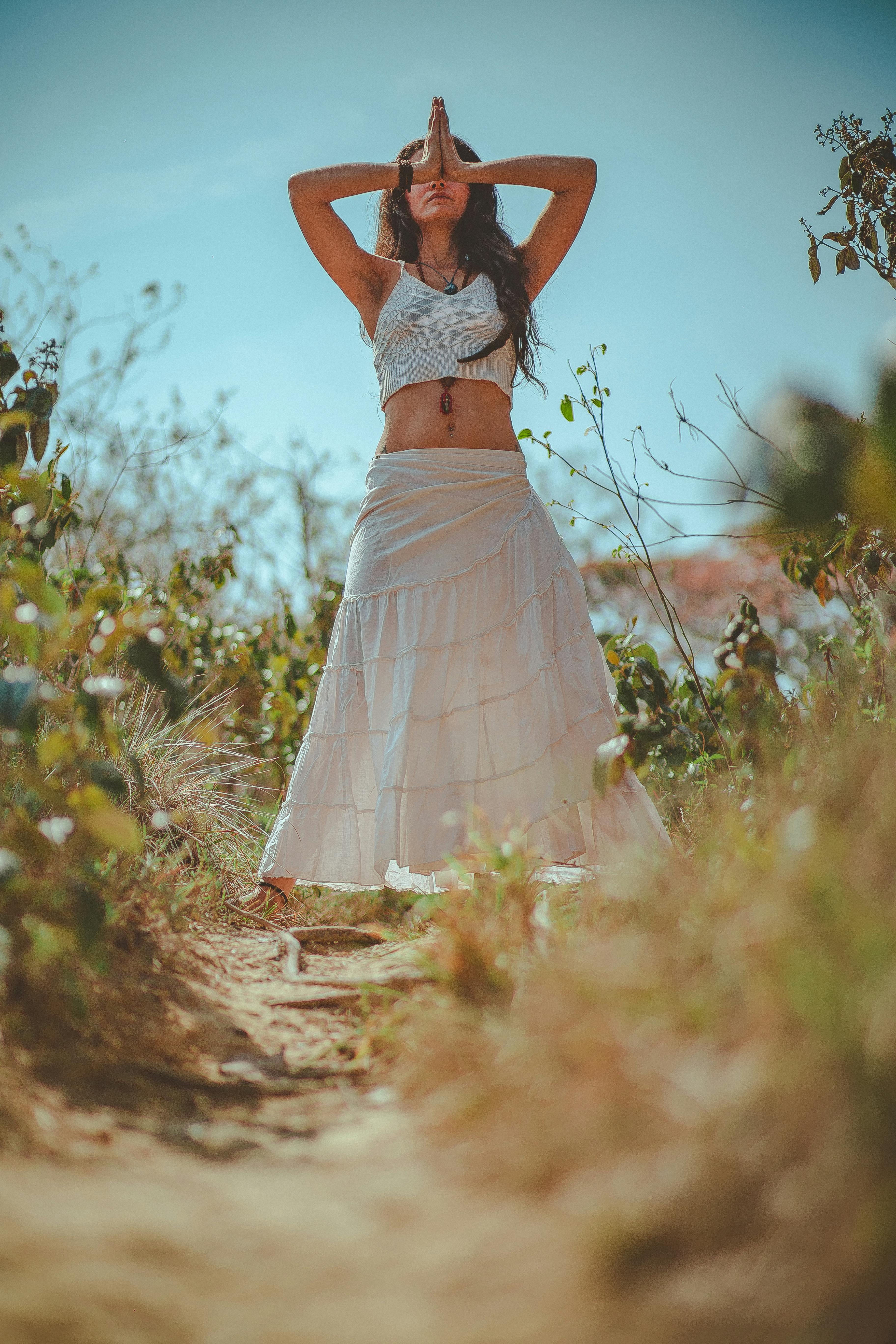 woman in white tank crop top on grass field