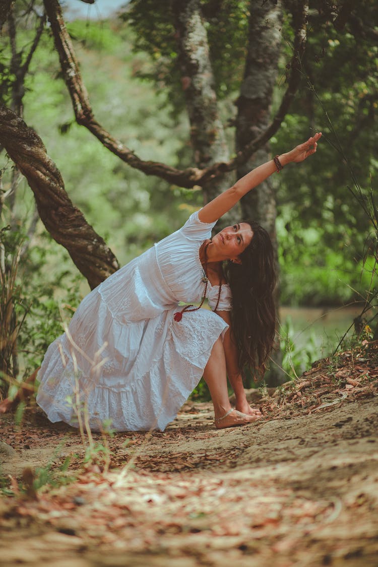 Photo Of Woman Bending Beside Tree