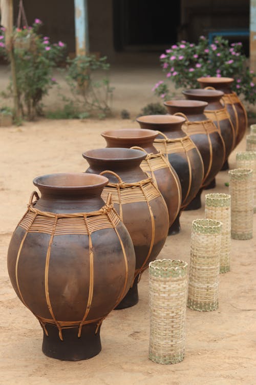 A row of vases sitting on the ground