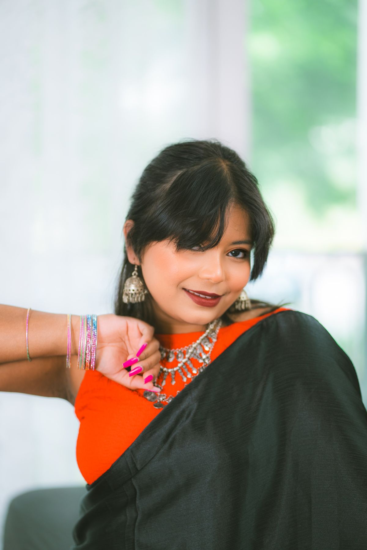 Stylish smiling woman in black saree and jewellery
