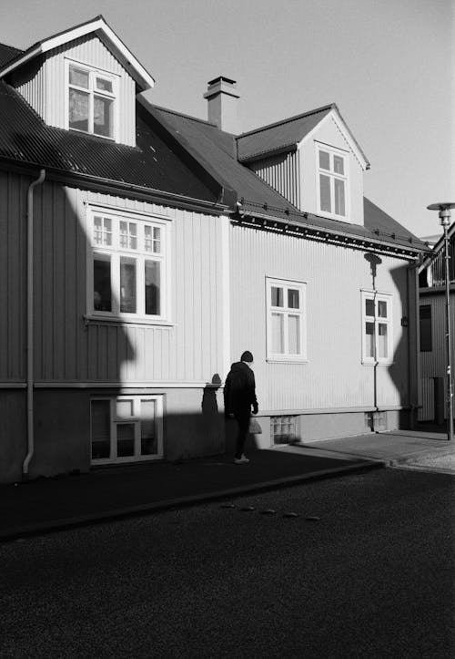A person standing in front of a house