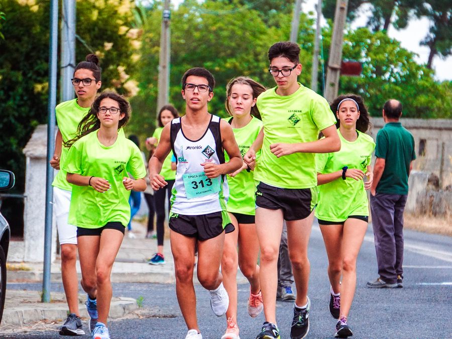 A running club in matching shirts mid-race