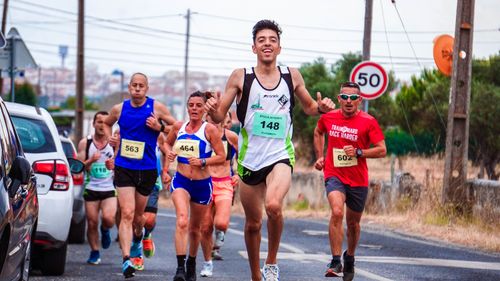 Free Vibrant scene of diverse runners enjoying a road race, showcasing fitness and competition. Stock Photo