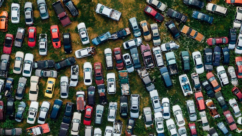 Aerial view of a scrapyard with various cars, showing where junk vehicles end up