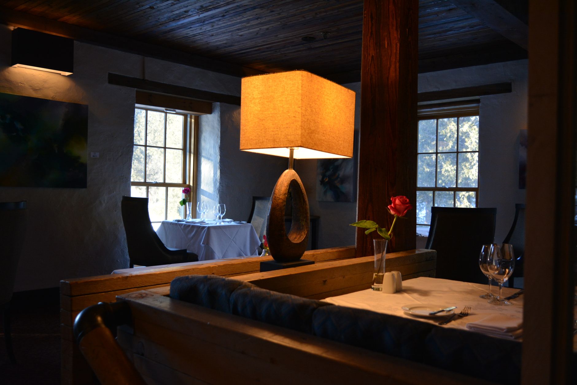 A minimalist, high-end private dining room with soft ambient lighting and an air of quiet exclusivity.