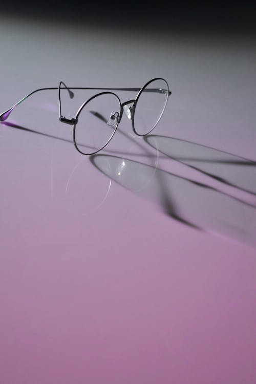 Photo of Round Eyeglasses on White Surface