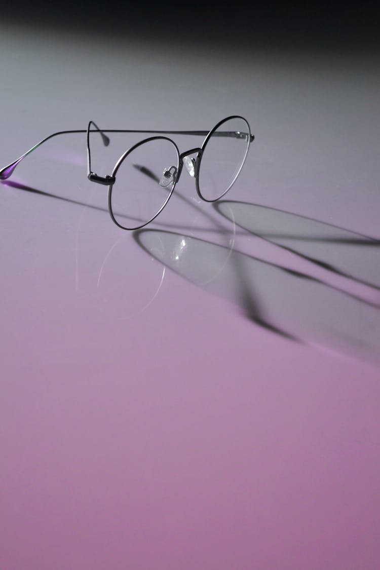 Photo Of Round Eyeglasses On White Surface