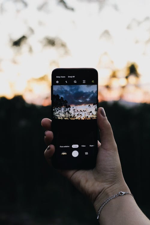 Free Photo of Person Holding Smartphone Stock Photo
