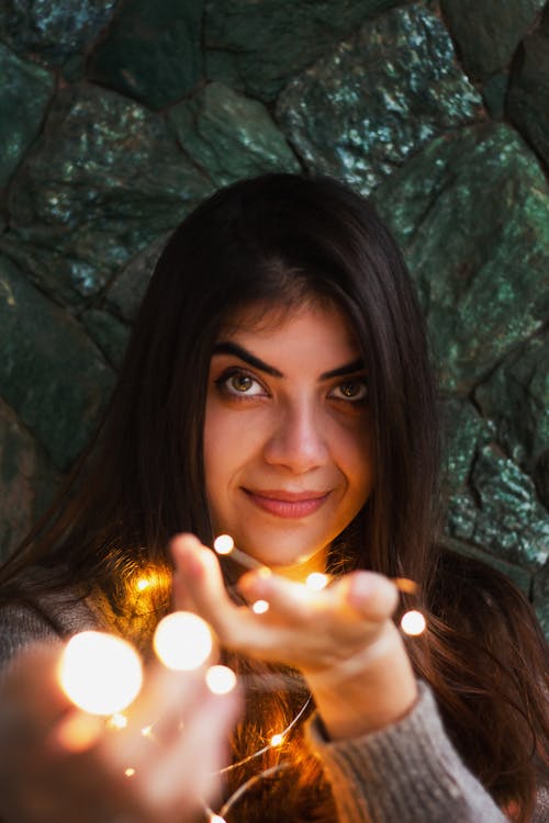 Photo of Woman Holding String Lights