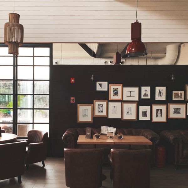 Leather chairs and framed prints along the side wall