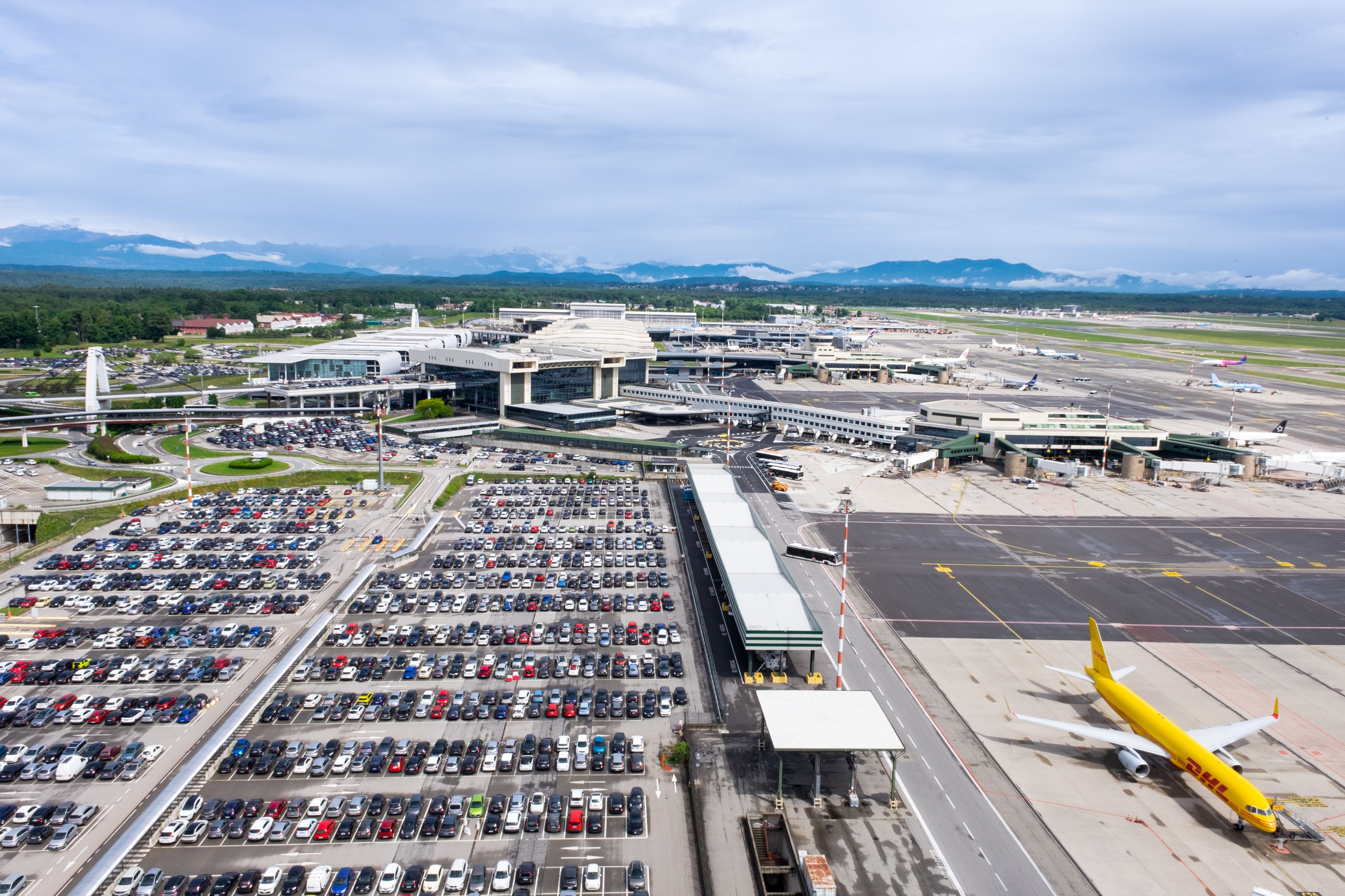 Airport parking lot with a plane nearby