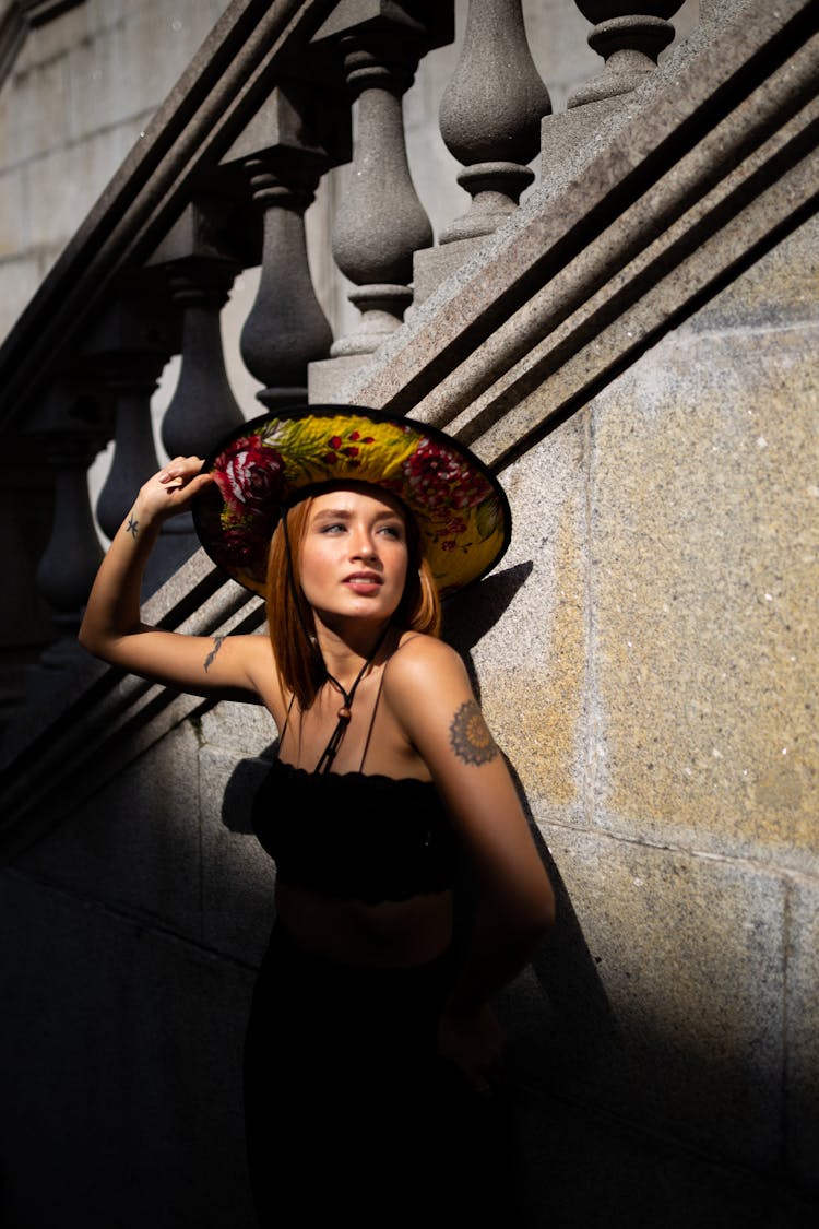 Photo Of Woman Wearing Sun Hat Leaning On Staircase