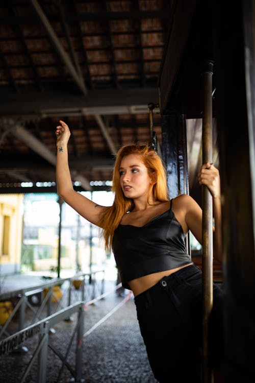 Woman In Black Crop Top Holding On Pole