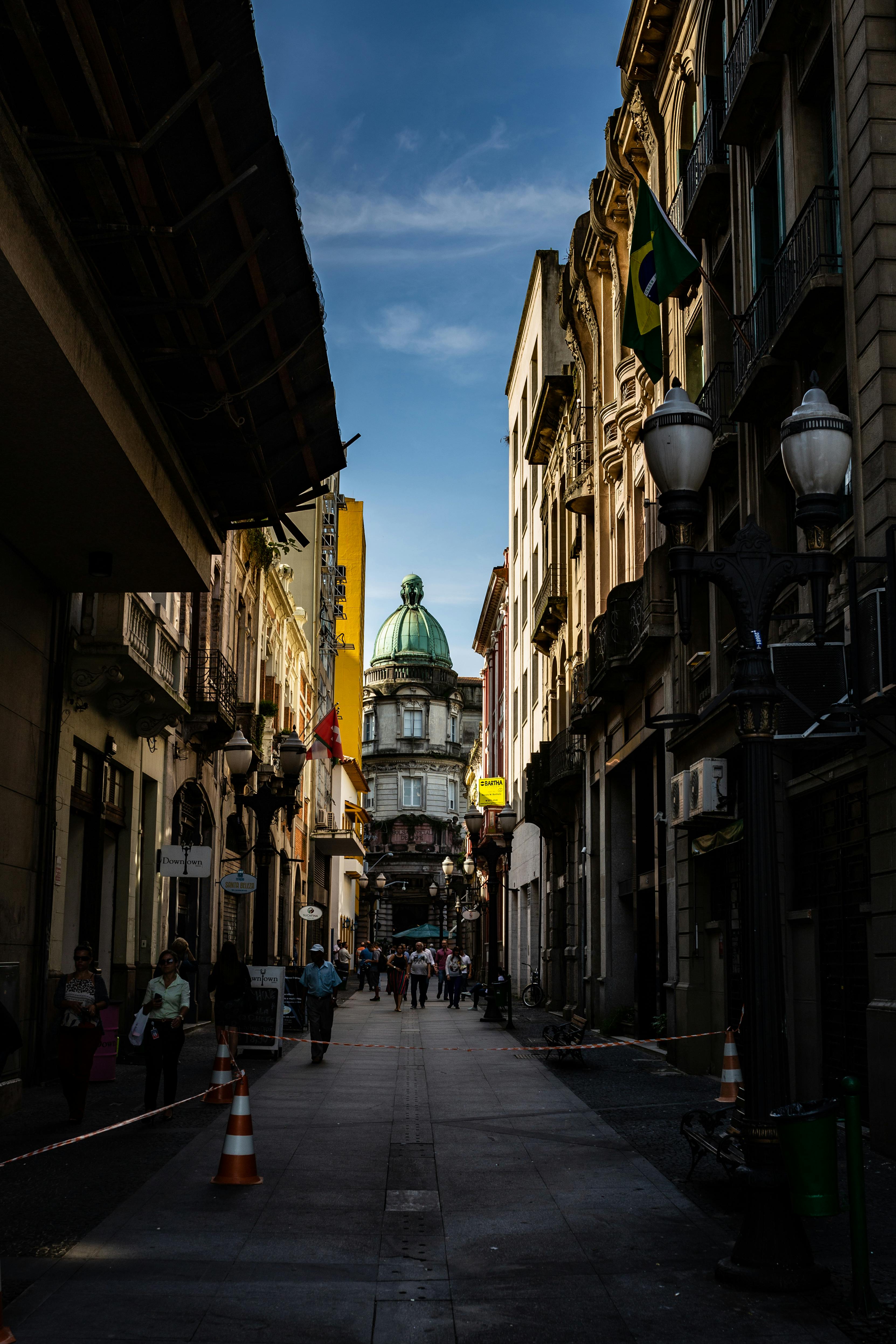 photo of people walking on alley near buildings