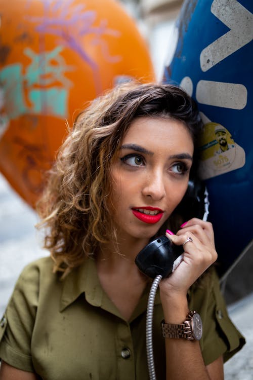 Close-Up Photo of Woman Holding Telephone