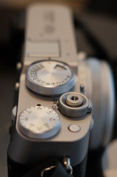 Detailed close-up of a vintage style camera focusing on the dials and knobs, perfect for photography enthusiasts.