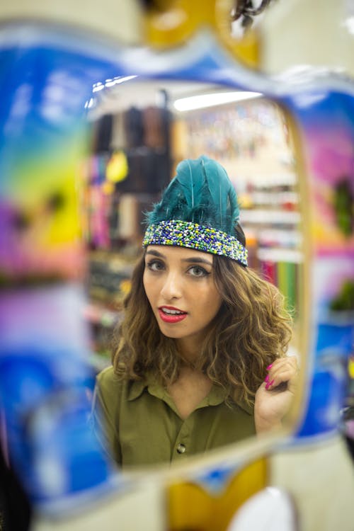 Photo of Woman Wearing Blue Feather Headdress