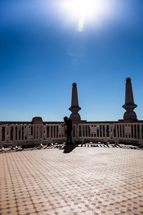 Free Photo of Person Leaning Against Terrace Railings Stock Photo