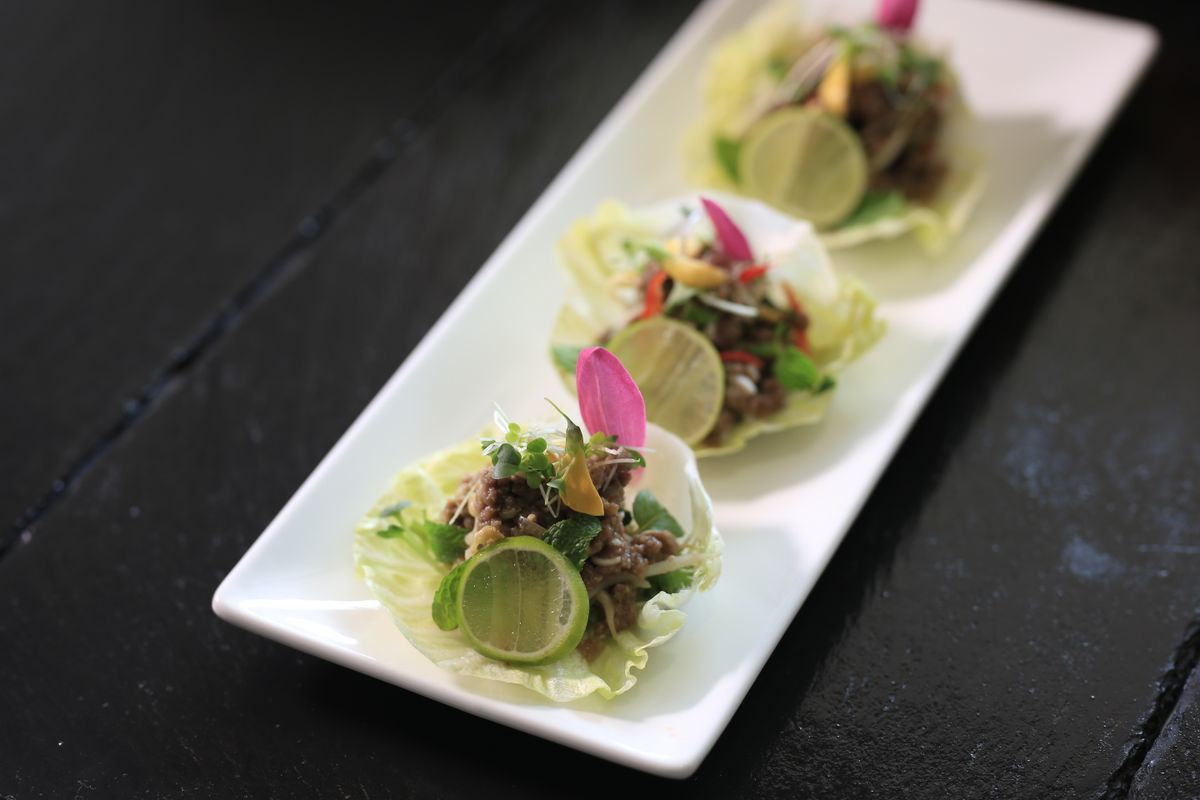 Lettuce cups with lime — the raw-vegetable side that larb is traditionally scooped into.