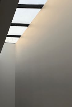 A minimalistic modern interior featuring a skylight and smooth walls, ideal for design inspiration.